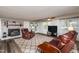 Cozy living room with brick fireplace, plush leather seating, and a bright, airy atmosphere at 3301 Manor Ridge Dr, Raleigh, NC 27603