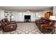 Bright living room featuring leather seating, neutral carpet, and natural light from large windows at 3301 Manor Ridge Dr, Raleigh, NC 27603