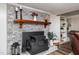 Cozy living room with a brick fireplace and decorative shelving for a charming aesthetic at 3301 Manor Ridge Dr, Raleigh, NC 27603