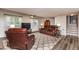 Comfortable living room with plush leather seating, a TV, and a stylish rug on modern flooring at 3301 Manor Ridge Dr, Raleigh, NC 27603