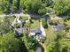 Aerial view of home with lush trees, greenery, a manicured front yard, and in-ground pool at 3704 Swann St, Raleigh, NC 27612