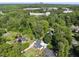 Aerial view of home with lush trees, greenery, and a cityscape in the background at 3704 Swann St, Raleigh, NC 27612