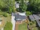 Aerial view of a home with an in-ground pool, a well-manicured front lawn, and mature trees at 3704 Swann St, Raleigh, NC 27612