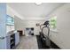 Bright finished basement with tile floor includes an exercise machine and storage at 3704 Swann St, Raleigh, NC 27612