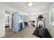 Finished basement boasts tile flooring and is well-lit, featuring a fitness area with exercise equipment at 3704 Swann St, Raleigh, NC 27612