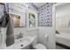 Charming powder room with custom wallpaper, beadboard, and a window with natural light at 3704 Swann St, Raleigh, NC 27612