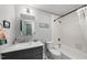 Well-lit bathroom featuring a tub and shower, stylish vanity, and attractive black and white tiled flooring at 3704 Swann St, Raleigh, NC 27612