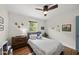 Bedroom showcasing hardwood floors, natural light, and a gray headboard at 3704 Swann St, Raleigh, NC 27612