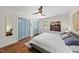 Bright bedroom with wood floors, natural light, a ceiling fan and ample closet space at 3704 Swann St, Raleigh, NC 27612