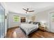 Comfortable bedroom featuring a ceiling fan, natural light, and hardwood floors at 3704 Swann St, Raleigh, NC 27612
