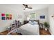 Bright bedroom with hardwood floors, a ceiling fan, and charming decorative touches at 3704 Swann St, Raleigh, NC 27612