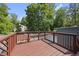 Wood deck features views of the backyard and swimming pool, surrounded by mature trees at 3704 Swann St, Raleigh, NC 27612
