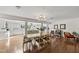 Elegant dining area open to kitchen, featuring hardwood floors and a modern chandelier at 3704 Swann St, Raleigh, NC 27612