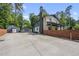 Side view of home showcasing the backyard, detached garage, and stone and painted brick at 3704 Swann St, Raleigh, NC 27612
