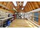 Bright garage space with exposed wood beams, workshop area, and storage at 3704 Swann St, Raleigh, NC 27612