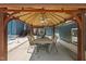 A shaded gazebo with dining table and seating adjacent to the outdoor swimming pool at 3704 Swann St, Raleigh, NC 27612
