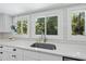 Close-up of the kitchen sink and window, showing white countertops and tiled backsplash at 3704 Swann St, Raleigh, NC 27612