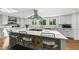 Spacious kitchen with a large island, bar seating, and modern stainless steel hood vent at 3704 Swann St, Raleigh, NC 27612