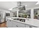 Open-concept kitchen showcasing a large island with gas range and a view into the living area at 3704 Swann St, Raleigh, NC 27612