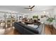Open concept living room and dining area with hardwood floors, modern lighting, and stainless appliances at 3704 Swann St, Raleigh, NC 27612