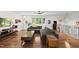 Living room with hardwood floors, neutral paint, and a modern ceiling fan at 3704 Swann St, Raleigh, NC 27612