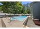 Backyard oasis featuring a pool and a deck surrounded by lush greenery at 3704 Swann St, Raleigh, NC 27612