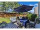 Inviting backyard patio with an umbrella-covered table and chairs, perfect for outdoor dining and relaxation at 3801 Althorp Dr, Raleigh, NC 27616