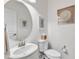 Bright half bath features a decorative mirror and artwork at 3801 Althorp Dr, Raleigh, NC 27616