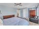 Bedroom with ceiling fan, wood-look floors, and blue bedding at 3801 Althorp Dr, Raleigh, NC 27616
