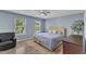 Cozy bedroom with a ceiling fan and sun-filled windows that allow a view of green, leafy trees at 3801 Althorp Dr, Raleigh, NC 27616
