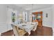 Formal dining room with hardwood floors, a classic china cabinet, and abundant natural light from the windows at 3801 Althorp Dr, Raleigh, NC 27616
