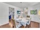 Bright dining room featuring hardwood floors, white wainscoting, and views into adjacent living spaces, perfect for gatherings at 3801 Althorp Dr, Raleigh, NC 27616