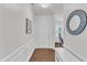 Bright foyer featuring hardwood floors, white wainscoting, and stylish decor elements creating a welcoming entrance at 3801 Althorp Dr, Raleigh, NC 27616