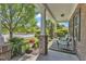 Inviting front porch with brick columns, comfortable seating, and views of the well-manicured front yard at 3801 Althorp Dr, Raleigh, NC 27616