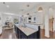 Spacious kitchen featuring an island with sink and views to the dining area, staircase, and living room at 3801 Althorp Dr, Raleigh, NC 27616
