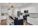 Modern kitchen featuring white cabinetry, stainless steel appliances, and a granite breakfast bar with seating at 3801 Althorp Dr, Raleigh, NC 27616