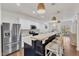 Open kitchen with stainless appliances, granite countertops and an island overlooking the living and dining area at 3801 Althorp Dr, Raleigh, NC 27616