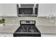 Close-up of kitchen appliances highlighting the gas range and built-in microwave at 3801 Althorp Dr, Raleigh, NC 27616
