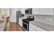 Bright kitchen featuring stainless steel appliances, white cabinets, and granite countertops at 3801 Althorp Dr, Raleigh, NC 27616