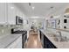 Open concept kitchen with granite counters, stainless appliances, and a view to the dining area at 3801 Althorp Dr, Raleigh, NC 27616