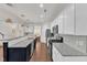 Open kitchen with granite counters, stainless appliances, and an island that flows into the dining area at 3801 Althorp Dr, Raleigh, NC 27616