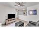 Upstairs living area with TV, leather chair, and ceiling fan at 3801 Althorp Dr, Raleigh, NC 27616