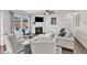 Bright living room featuring a fireplace, ceiling fan, plush seating, and dark hardwood floors at 3801 Althorp Dr, Raleigh, NC 27616