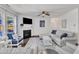 Bright and airy living room features plush seating, a fireplace, dark floors, and many windows at 3801 Althorp Dr, Raleigh, NC 27616