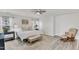 Bright main bedroom features a ceiling fan and a rocking chair at 3801 Althorp Dr, Raleigh, NC 27616