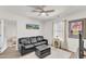 Sitting room with leather sofa, a ceiling fan, and wood-look floors at 3801 Althorp Dr, Raleigh, NC 27616