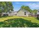 Well-kept backyard with green lawn, partial shade, fenced boundary and the rear exterior of the house at 3808 Hopper St, Raleigh, NC 27616