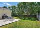 Spacious backyard featuring lush green grass, mature trees, patio and grilling area at 3808 Hopper St, Raleigh, NC 27616