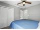 Bedroom with a ceiling fan, closet, and door. The walls are painted gray at 3808 Hopper St, Raleigh, NC 27616