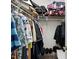 Organized walk-in closet with hanging clothes and storage shelves, maximizing space and functionality at 3808 Hopper St, Raleigh, NC 27616